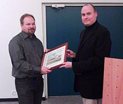 Tuomas Kuosmanen (left) receives the first prize of FoMA's photo competition.