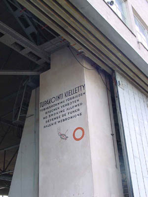 Original details from the 1930's still adorn the architecturally acclaimed buildings of Helsinki-Malmi Airport. In the big hangar, smoking is prohibited in six languages: Finnish, Swedish, German, English, French and Polish.